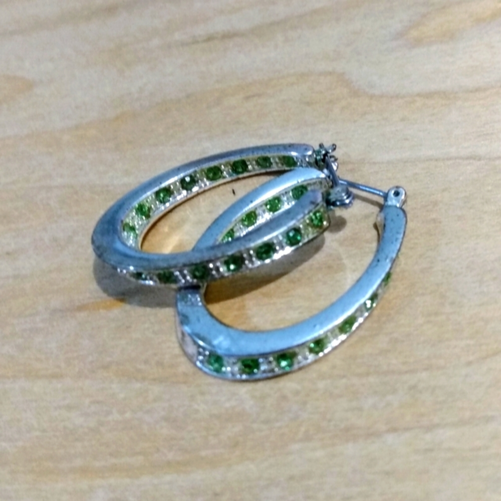 Vintage horse shoe shaped earrings with light green and clear stones. Good quali